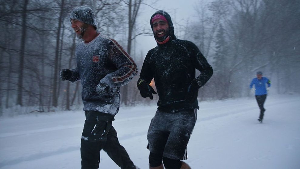 NEW YORK, NY - JANUARY 23: Men jog in blizzard-like conditions on January 23, 2016 in the Brooklyn borough of New York City. The Northeast and parts of the South are experiencing heavy snow and ice from a slow moving winter storm. Multiple deaths from traffic accidents have already been reported as the storm makes its way up the coast. (Photo by Spencer Platt/Getty Images)