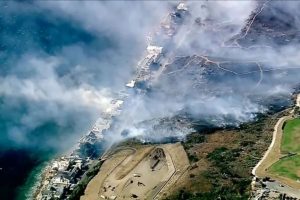 Los Angeles County Fire Department crews scrambled to contain a fire fueled by erratic wind gusts that pushed flames through dry brush near Broad Beach along Pacific Coast Highway in Malibu on Wednesday.