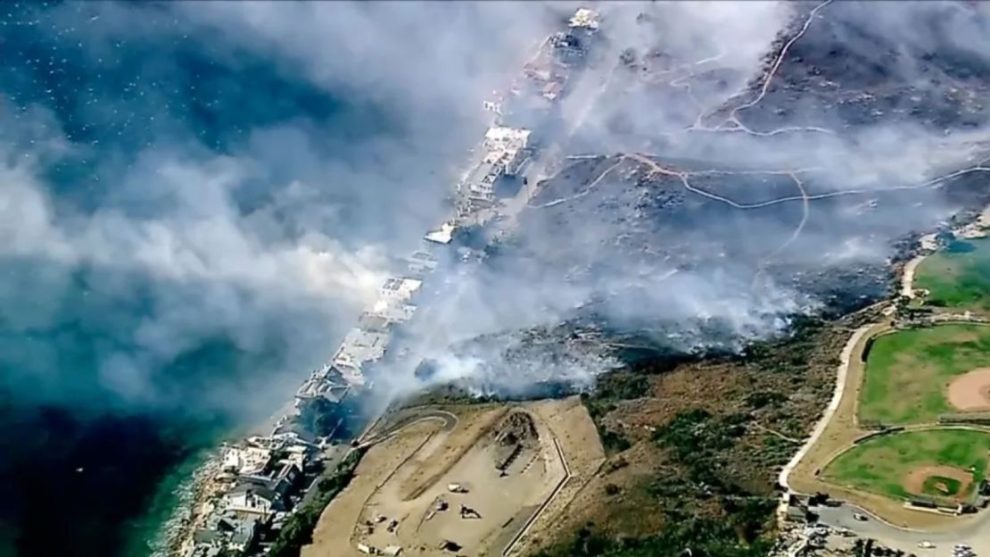 Los Angeles County Fire Department crews scrambled to contain a fire fueled by erratic wind gusts that pushed flames through dry brush near Broad Beach along Pacific Coast Highway in Malibu on Wednesday.