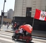 A protester holds a Peruvian flag at a protest in front of Congress as transporters demand greater protection amid a wave of extortions and attacks in Lima, Peru, on October 23, 2024.