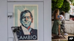 A campaign poster promoting the Puerto Rico Independence Party and the Citizen Victory Movement gubernatorial candidate Juan Dalmau is displayed on an electrical box in San Juan, Puerto Rico, Saturday, Nov. 2, 2024. AP