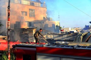 A member of the rescue teams in a building destroyed by an Israeli bombardment against the Syrian capital, Damascus (file)