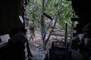 Private Anna, from the Ukrainian 120th Reconnaissance Regiment, picks up her attack drone after a flight, inside the town of Chasiv Yar.