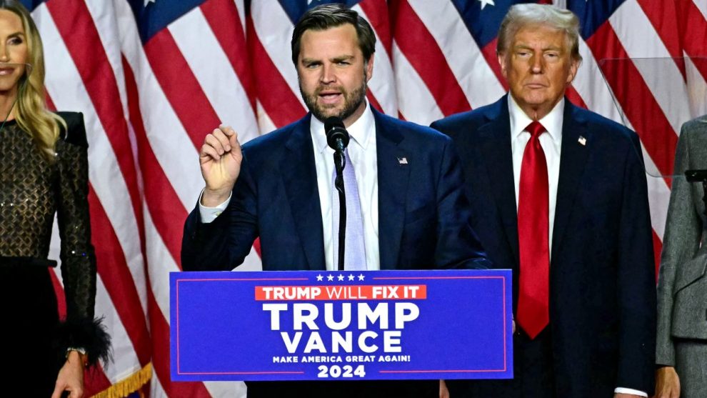 US Senator from Ohio and Republican vice presidential candidate JD Vance (C) speaks alongside former US President and Republican presidential candidate Donald Trump during an election night event at the West Palm Beach Convention Center in West Palm Beach, Florida, on November 6, 2024. Republican former president Donald Trump closed in on a new term in the White House early November 6, 2024, just needing a handful of electoral votes to defeat Democratic Vice President Kamala Harris. (Photo by Jim WATSON / AFP) (Photo by JIM WATSON/AFP via Getty Images)