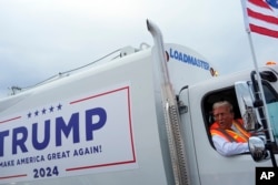 Republican presidential candidate Donald Trump speaks to reporters while sitting in a garbage truck on Wednesday, Oct. 30, 2024, in Green Bay, Wisconsin. (AP Photo/Julia Demaree Nikhinson)