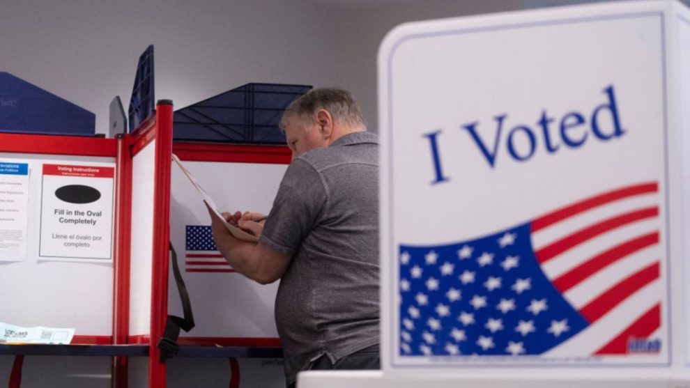 A voter with their ballot at a voting center at the Elena Bozeman Government Center in Arlington, Virginia, on September 20, 2024 during early in-person voting.