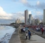 People walk on the seafront boardwalk during a march in protest against the U.S. trade embargo on Cuba, in Havana, Cuba, on Dec. 20, 2024.