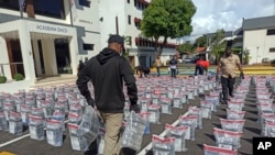 Dominican Republic Police officials display the hidden drug packages in Santo Domingo, the country's capital, on Friday, December 6, 2024. (AP Photo/Jose Adames).