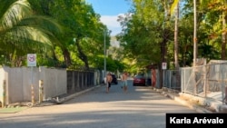 Tourists walk along the approaches to El Zonte Beach, in El Salvador, now paved.