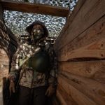 A Marine from the Ukrainian Army's 124th Brigade walks into a trench in the city of Kherson.