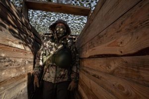 A Marine from the Ukrainian Army's 124th Brigade walks into a trench in the city of Kherson.