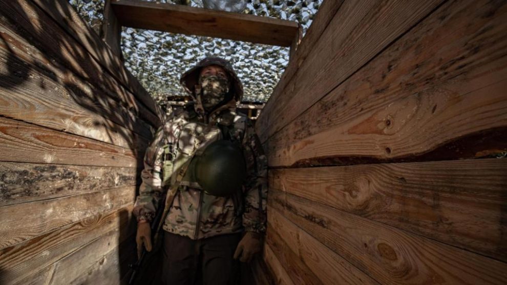 A Marine from the Ukrainian Army's 124th Brigade walks into a trench in the city of Kherson.