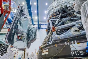 Technicians install the main instrument on NASA's Nancy Grace Roman Space Telescope, called the Wide Field Instrument (at left),