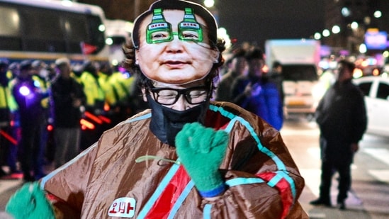 A man wearing a mask of South Korean President Yoon Suk Yeol dances in front of the National Assembly in Seoul, South Korea, on Dec. 4, 2024, after Yoon declared martial law. (AFP)