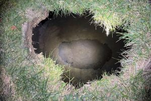 An image provided by Pennsylvania State Police shows the top of a sinkhole in Marguerite, Pennsylvania, where rescuers were searching for a missing woman.