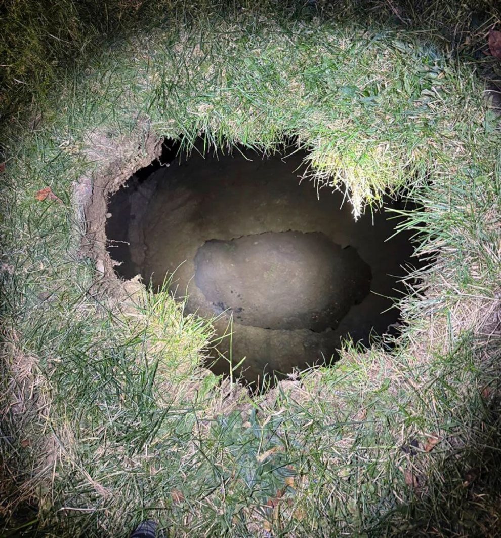 An image provided by Pennsylvania State Police shows the top of a sinkhole in Marguerite, Pennsylvania, where rescuers were searching for a missing woman.