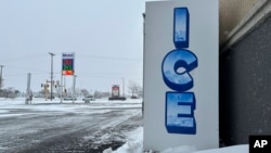 A convenience store's ice bin is a sign of the times on a windy winter day in Bismarck, N.D., Thursday, Dec. 19, 2024. (AP Photo/Jack Dura)