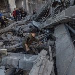 Palestinians inspect rubble in a building after an Israeli attack in the Gaza Strip