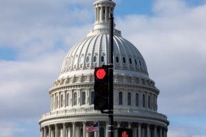 What is a partial US government shutdown and what is the debt ceiling?