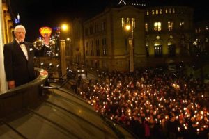 Jimmy Carter greets attendees of a torchlight procession in central Oslo, before the Norwegian Nobel Prize Committee banquet, December 10, 2002.