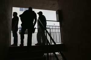 U.S. Immigration and Customs Enforcement (ICE) agents arrive at a home to detain an immigrant on October 14, 2015, in Los Angeles, California. ICE agents said the immigrant, a legal resident with a green card, was a convicted felon and gang member in the Canoga Park area.