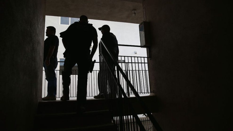 U.S. Immigration and Customs Enforcement (ICE) agents arrive at a home to detain an immigrant on October 14, 2015, in Los Angeles, California. ICE agents said the immigrant, a legal resident with a green card, was a convicted felon and gang member in the Canoga Park area.