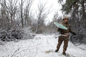 Ukrainian soldier managing a Starlink terminal.