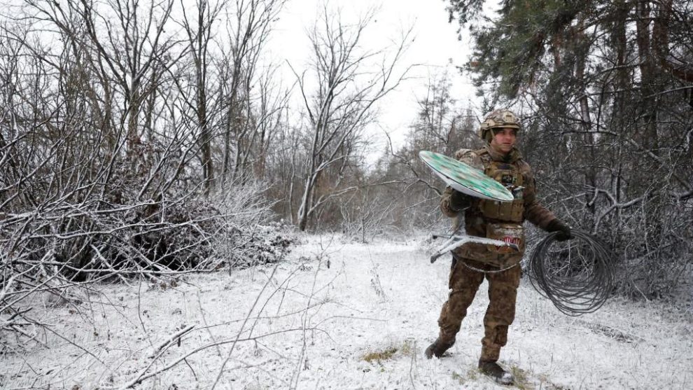 Ukrainian soldier managing a Starlink terminal.