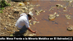 A local man near the San Sebastián River, La Unión, observes the color of the river after mining in the area. [Fotografía: Mesa Frente a la Minería Metálica en El Salvador]