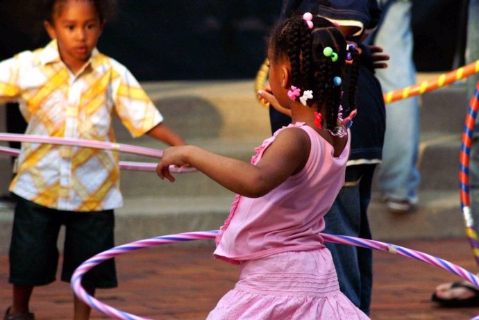 Children playing with hula hoops.