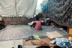 A boy whose family fled the violence sits in a makeshift shelter in Port-au-Prince.