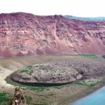 The mysterious eruption occurred at the Zavaritskii volcano (Simushir island, Kuril Islands). The explosion generated a 3 kilometer wide caldera that revealed spectacular red, black and white layers formed by past eruptive deposits.