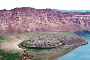 The mysterious eruption occurred at the Zavaritskii volcano (Simushir island, Kuril Islands). The explosion generated a 3 kilometer wide caldera that revealed spectacular red, black and white layers formed by past eruptive deposits.