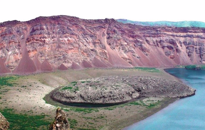 The mysterious eruption occurred at the Zavaritskii volcano (Simushir island, Kuril Islands). The explosion generated a 3 kilometer wide caldera that revealed spectacular red, black and white layers formed by past eruptive deposits.