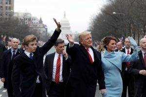 Donald Trump and his family walk down Pennsylvania Avenue to the White House